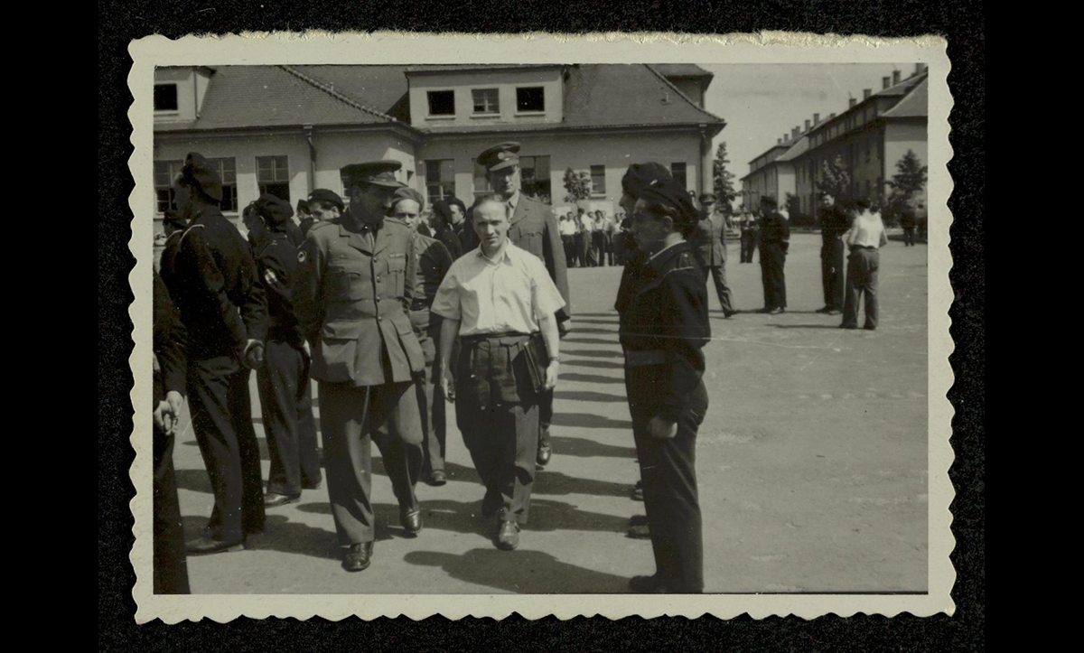 Polish-born survivor of Auschwitz and Belsen, Yossele (Josef) Rosensaft, pictured here in the white shirt, was elected Chairman of the Central Committee of Jews in the British Zone. Here he is attending a ceremony involving the handover of a car to the Jewish police force in Belsen. The Central Committee included departments such as the Health Department, led by Hadassa Bimko (who later married Rosensaft), and the Cultural Department. The Cultural Department included survivors Rafael Olevsky, Paul Trepman, David Rosenthal, who also edited the DP journal Unzer Sztyme together, and Samy Feder and Sonia Baczkowska, who were part of the camp’s theatre groups. The Committee was a diverse group with members representing a wide range of political beliefs and degrees of religiosity; all had been involved in Jewish communal affairs before the war, but none had been leaders. 